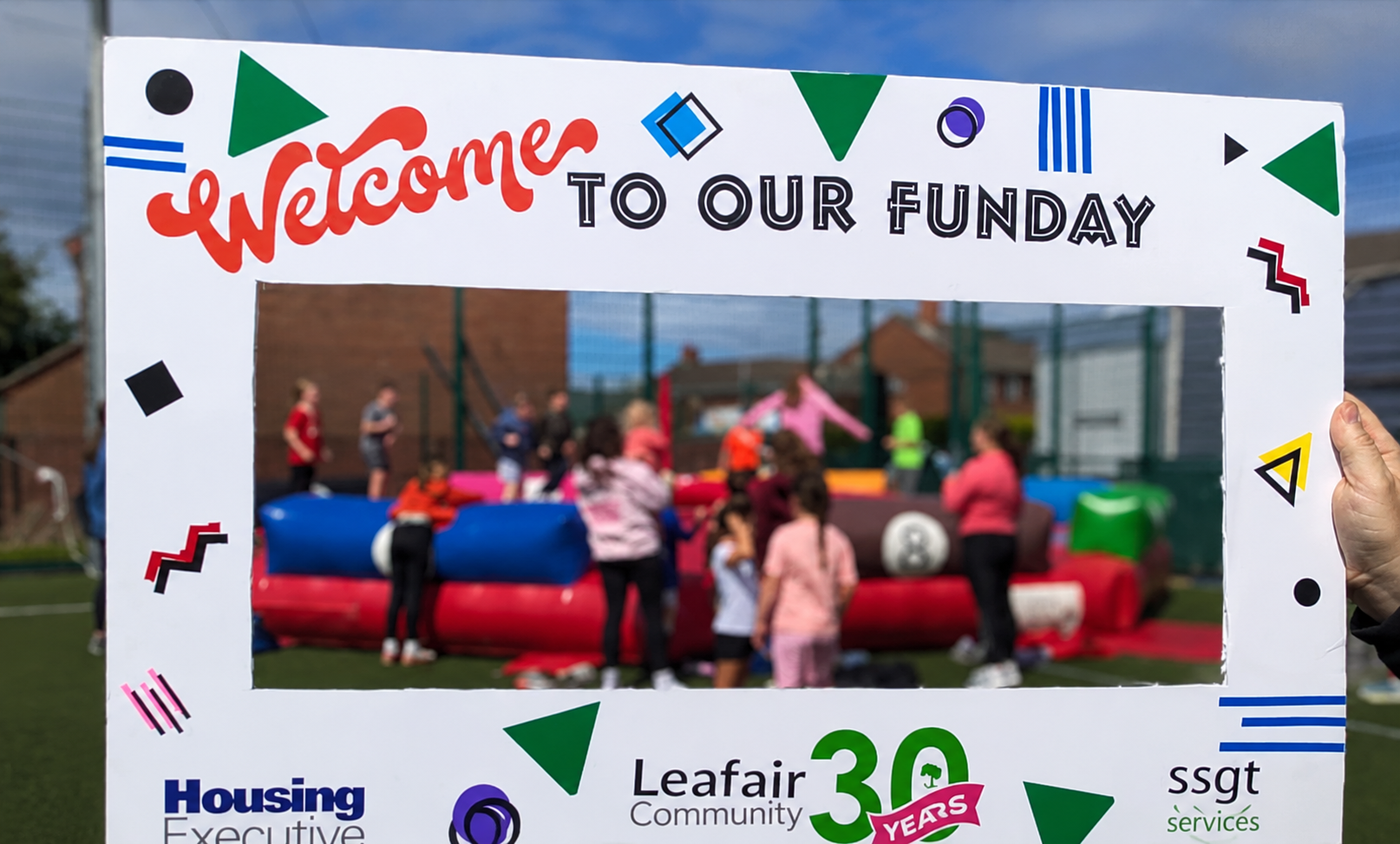 Leafair community volunteers gathered at a local event with signage visible